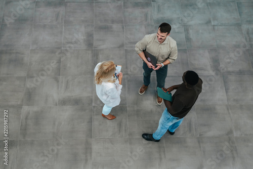 Business colleagues collaborating during informal office meeting from above
