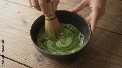 Preparing Traditional Japanese Green Tea with Bamboo Whisk Whisking Matcha Powder in Ceramic Bowl, 4K