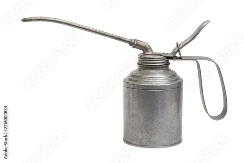 Old vintage metal oil can with a long spout and handle, showing signs of wear on a white background