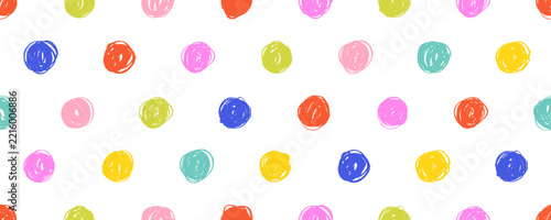 Playful polka dots seamless pattern drawn with multicolored pencils or crayons. Hand drawn rough edges circles and dots naive background. Baby Birthday polka dot background or wrapping paper.