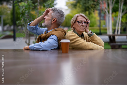 Mature couple showing emotional distance after argument