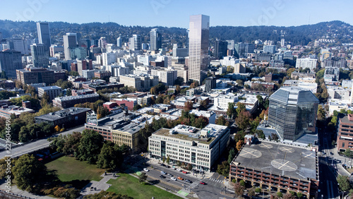aerial  shot of downtown Portland, Oregon showing the historic White Stag sign, taken in late 2026.