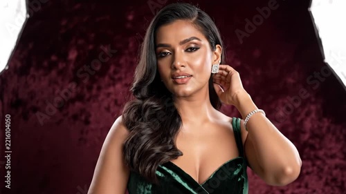 Elegant Woman in Green Velvet Dress Posing Glamorously, Studio Portrait