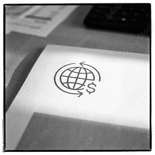 Global Finance and International Currency Exchange Icon Printed on Paper at Office Desk Workplace Concept