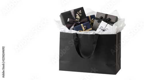 Black shopping bag filled with beautifully wrapped gift boxes