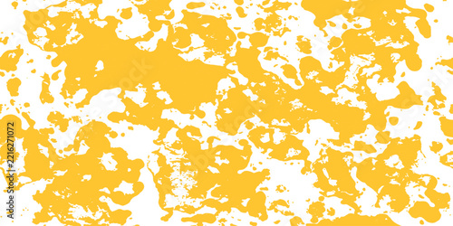Yellow paint splatters on white background in abstract pattern for creative design concepts