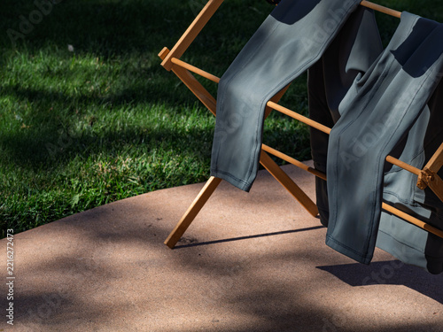 Athletic leggings air drying on wooden rack on sunny patio