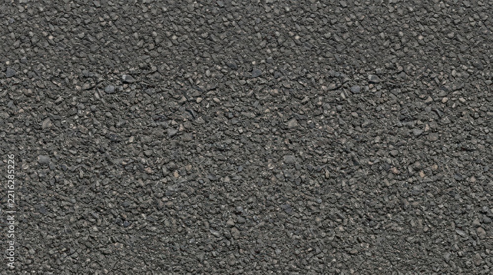 Fototapeta premium Close up of rough gray asphalt texture with natural aggregate detail