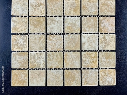 Travertine-style ceramic mosaic sheet ready for wall or floor installation against a dark background