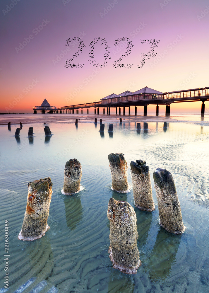 Fototapeta premium A New Journey Begins – 2027 in the Sky Above a Romantic Beach at Sunset
