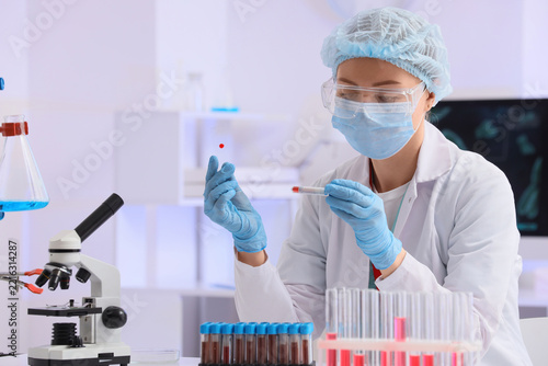 Medical research and clinical diagnostics, scientist analyzing blood sample i...