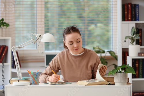 Education and academic research, student studying with books and taking notes...