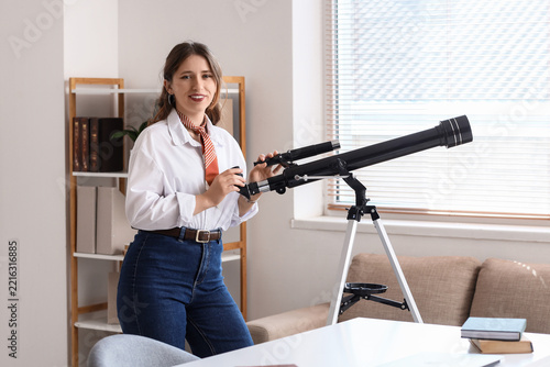 Future vision and career planning, young woman using a telescope in a bright ...