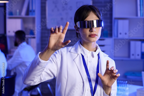 Medical innovation and virtual reality, scientist using futuristic vr glasses...