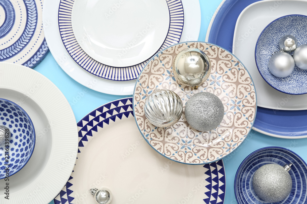 Fototapeta premium Beautiful Christmas table setting with baubles on blue background