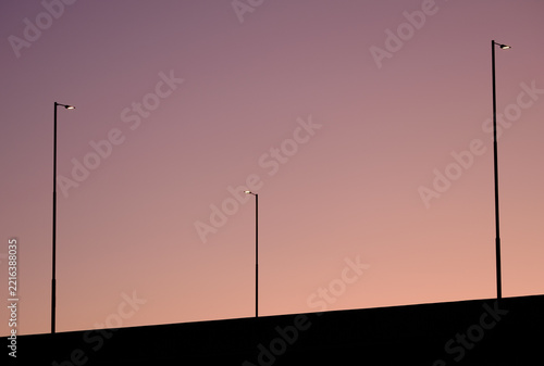 Minimalist Streetlights Against Twilight Sky