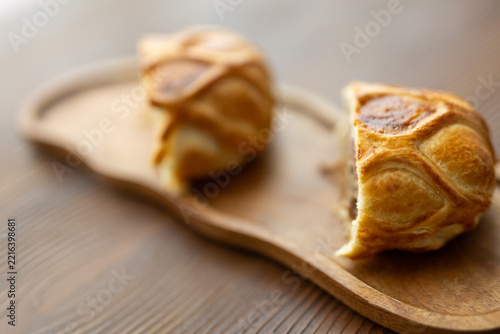 Gourmet Beef Wellington pastry sliced on a rustic wooden board