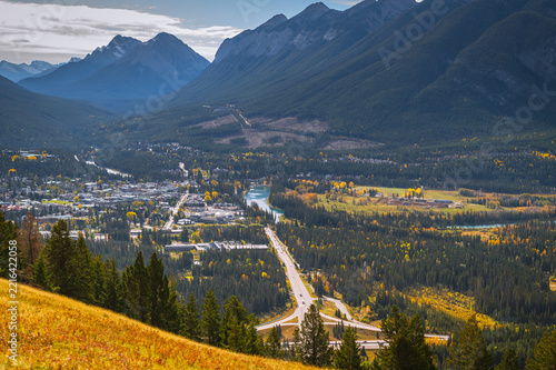 Serene mountain valley town landscape in canada surrounded by forest highway and majestic peak offering peaceful autumn travel view