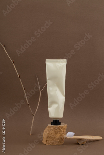 White tube of cream on a brown background