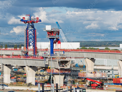 Aerial view of high speed rail construction featuring concrete pillars and specialized machinery in the United Kingdom.