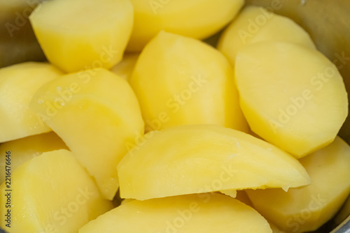 Whole peeled boiled potatoes in a saucepan
