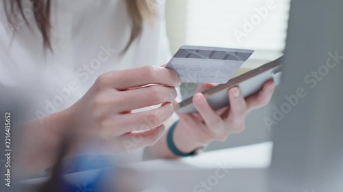 Close Up of Woman Using Credit Card and Smartphone for Online Shopping