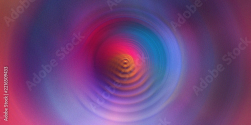 Vibrant rainbow color circles with radial motion blur create dynamic hypnotic swirl effect.