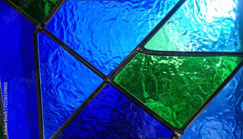 Stained Glass Panel Closeup with Vivid Blue and Green Geometric Shapes art concept