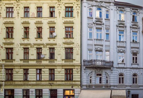 Obraz na plátně Multi-story historic buildings with light yellow and blue-gray Neo-Baroque and Secessionist facades with symmetrical windows and fine stucco ornamentation, historic center of Brno, Czech Republic