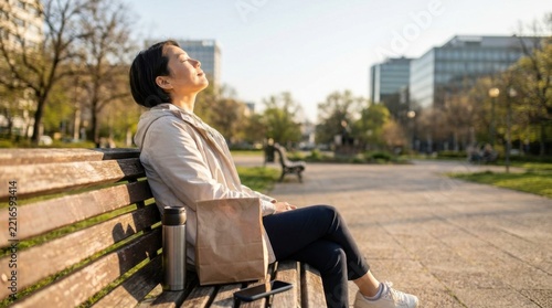 Woman Relaxing on Park Bench with Eyes Closed in Sunlight
