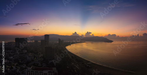 Sunrise over Quy Nhon, Vietnam, from aerial level looking toward the coastline. Peaceful tropical coastal landscape panorama