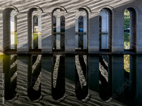 Water reflections of arched bridge construction