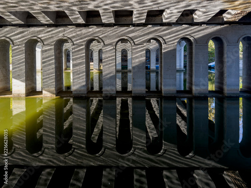 Water reflections of arched bridge construction
