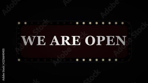 We are open neon sign with glowing light bulbs on a dark background