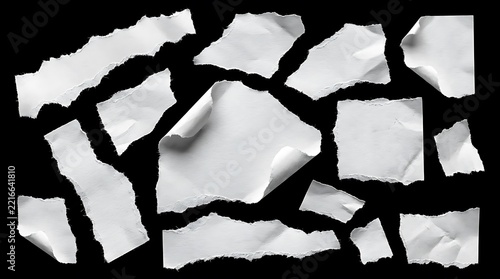 Collection of torn white paper pieces isolated on a black background for design elements