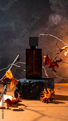Dark Moody Luxury Autumn Fragrance: Moody autumn fragrance display featuring dark amber glass perfume bottle