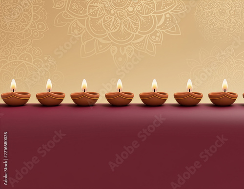 Row of Lit Diya Oil Lamps for Diwali Celebration With Decorative Mandala Background