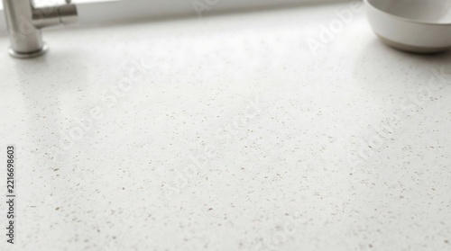 Modern white quartz kitchen countertop with stainless steel faucet