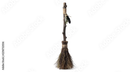 Rustic Witch Broomstick with Natural Twigs and Feather Decoration Isolated on White Background for Halloween Decoration