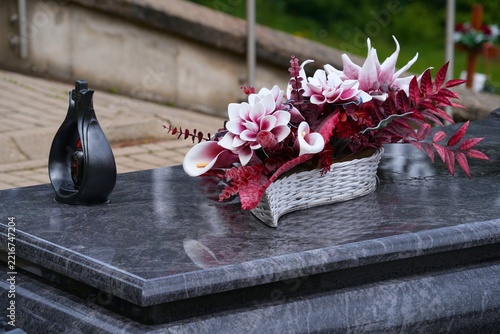 Poland grave fancy plastic flower decoration. Cemetery ornaments in Szklarska Poreba, Poland.