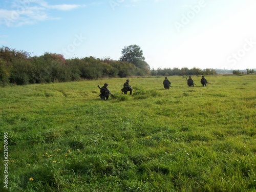 Danish army soldiers out in  military uniforms in the green forests around Sønderborg, Denmark