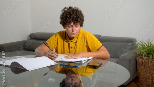 Fotografie 12 year old boy child suffering from a migraine headache – student experiencing