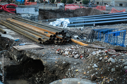 Construction site with metal pipes and excavation work