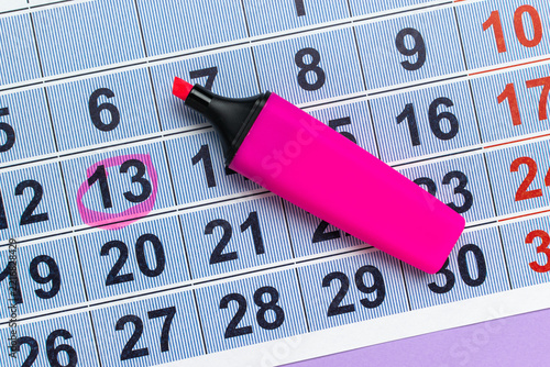 Pink Highlighter and Calendar: Highlighting Unlucky Number 13 for Important Reminder
