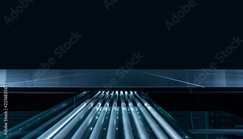 Glowing fluorescent tubes illuminating a dark abstract background