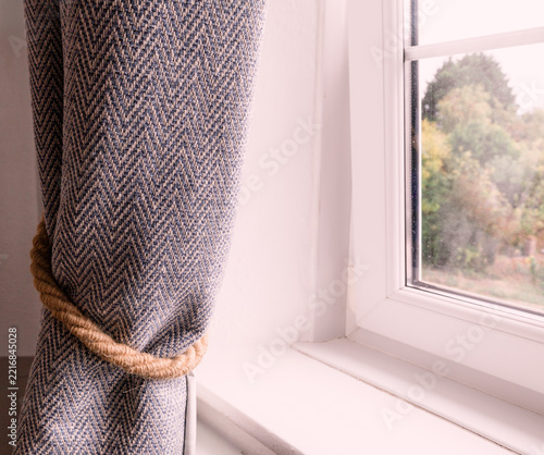 Rope Tie Back On A Bedroom Curtain In A Devon Fisherman's Cottage