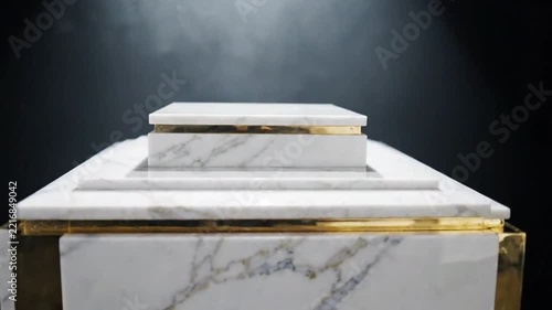 Close-up of white marble pedestal with gold accents in spotlight