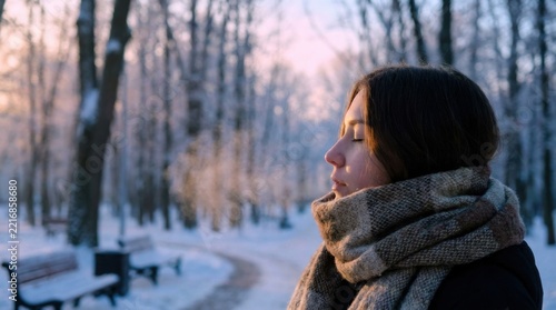 Woman in Warm Scarf Standing in Snowy Woods at Twilight