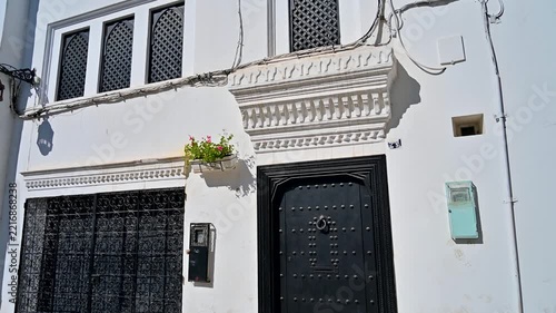 Traditional moroccan building with white walls and black doors in Tangier