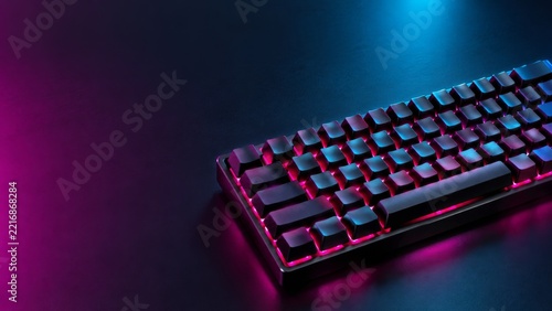 Black Keyboard with Magenta Underglow on a Dark Desk Background